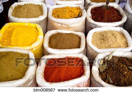 Stock Photo - Variety of colorful Indian spices in sacks. Fotosearch