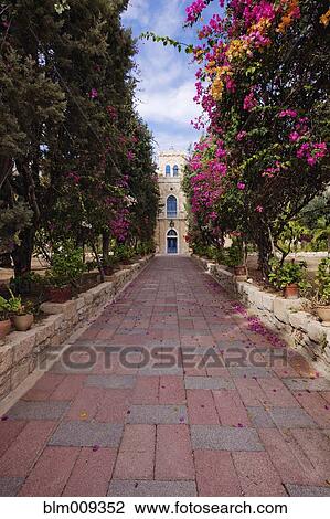 Stock Image - Walkway leading to monastery. Fotosearch