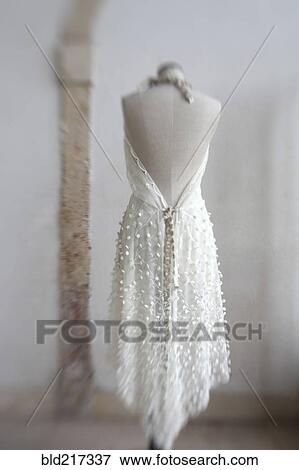 Stock Photo - Wedding dress hanging on mannequin. Fotosearch