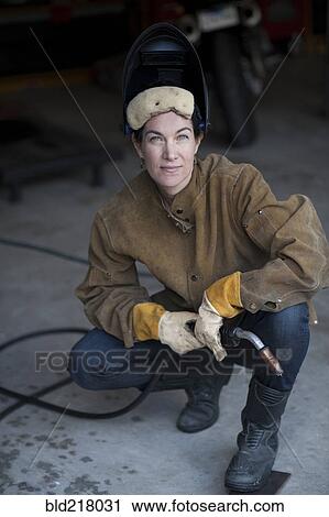 Welder crouching in workshop View Large Photo Image Stock Image - Welder crouching in workshop. Fotosearch
