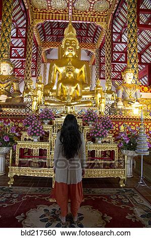 Woman admiring Buddha statue in temple View Large Photo Image Stock Image - Woman admiring Buddha statue in temple. Fotosearch