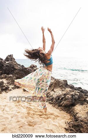 Woman dancing on rocky beach View Large Photo Image Stock Photo - Woman dancing on rocky beach. Fotosearch