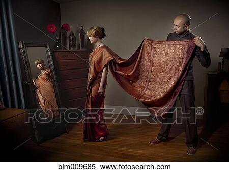 Woman dressing in traditional Indian clothing View Large Photo Image Stock Photography - Woman dressing in traditional Indian clothing. Fotosearch