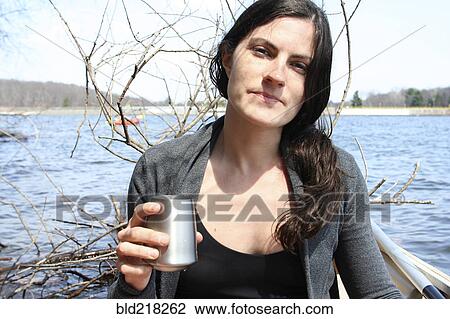 Woman drinking with metal cup in boat on lake View Large Photo Image Stock Image - Woman drinking with metal cup in boat on lake. Fotosearch