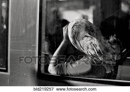 Stock Photo - Woman in headscarf riding in train. Fotosearch