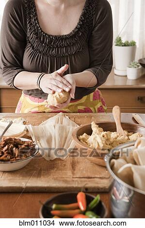 Picture - Woman making tamales. Fotosearch