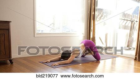 Woman practicing yoga in studio View Large Photo Image Stock Photo - Woman practicing yoga in studio. Fotosearch