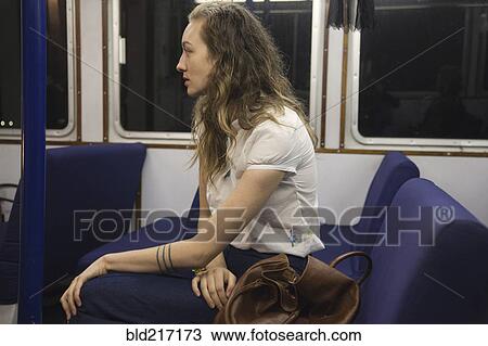 Stock Image - Woman riding train. Fotosearch