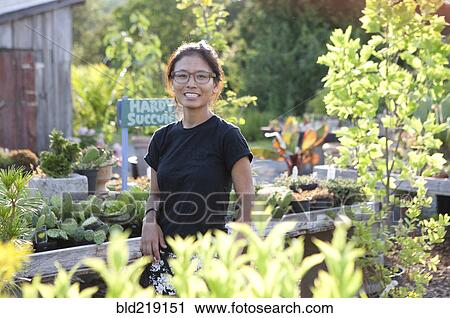 Stock Image - Woman shopping at farmers market. Fotosearch