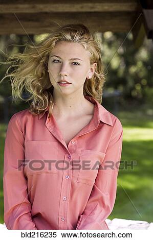 Stock Photography - Woman sitting outdoors. Fotosearch