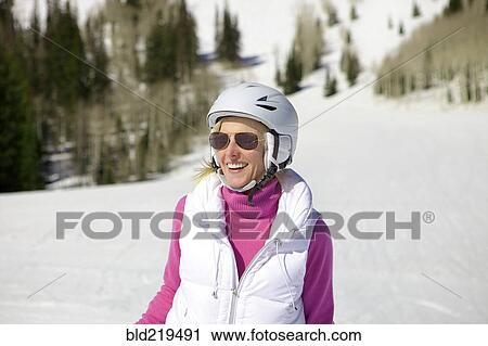 Stock Image - Woman skiing on snowy slope. Fotosearch