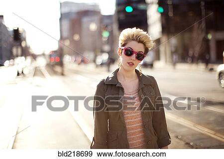 Stock Photo - Woman standing in city intersection. Fotosearch