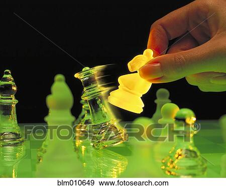Stock Photo - Woman using chess knight to knock over queen. Fotosearch