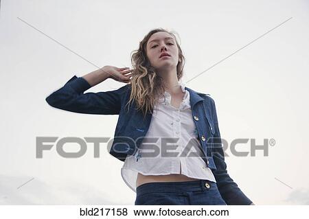 Woman wearing jacket under cloudy sky View Large Photo Image Stock Photo - Woman wearing jacket under cloudy sky. Fotosearch
