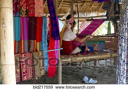 Woman weaving fabric on traditional loom in studio View Large Photo Image Stock Photo - Woman weaving fabric on traditional loom in studio. Fotosearch