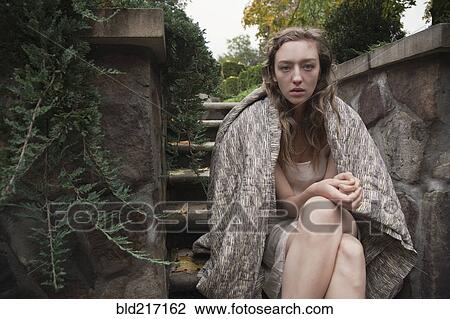 Woman wrapped in blanket sitting on stone steps View Large Photo Image Stock Image - Woman wrapped in blanket sitting on stone steps. Fotosearch