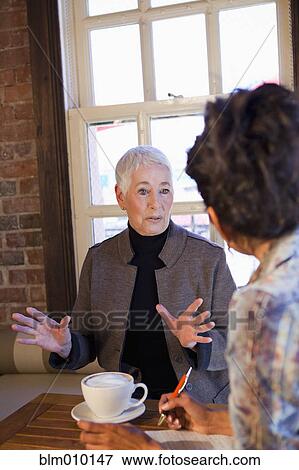 Women drinking coffee in cafe View Large Photo Image Stock Photo - Women drinking coffee in cafe. Fotosearch
