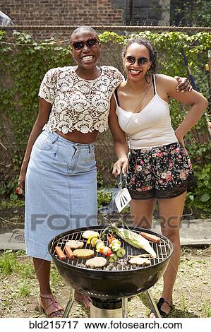Women grilling vegetables at backyard barbecue View Large Photo Image Stock Photo - Women grilling vegetables at backyard barbecue. Fotosearch