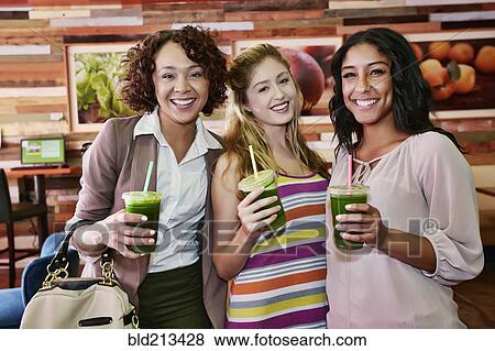 Women having juice together in cafe View Large Photo Image Stock Photo - Women having juice together in cafe. Fotosearch