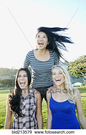 Women playing in field outdoors View Large Photo Image Stock Photo - Women playing in field outdoors. Fotosearch