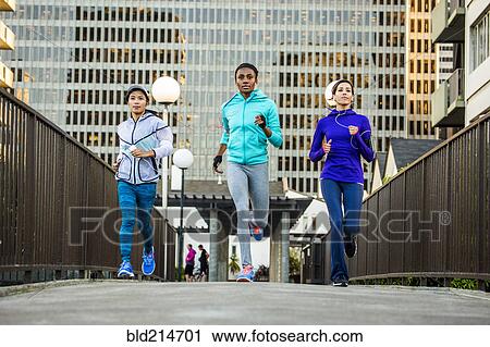Stock Image - Women running in city. Fotosearch