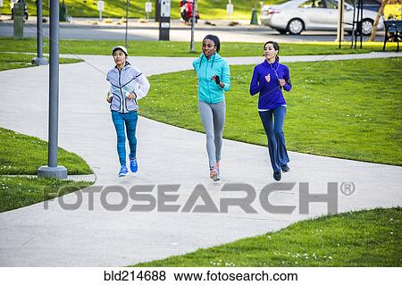 Stock Photo - Women running in park. Fotosearch