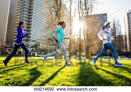 Stock Image - Women running in urban park. Fotosearch