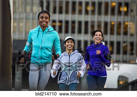 Women running near highrise building View Large Photo Image Stock Image - Women running near highrise building. Fotosearch