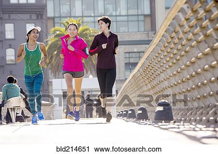 Women running on urban footbridge View Large Photo Image Stock Image - Women running on urban footbridge. Fotosearch