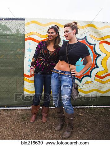 Women smiling near multicolor mural View Large Photo Image Stock Photo - Women smiling near multicolor mural. Fotosearch