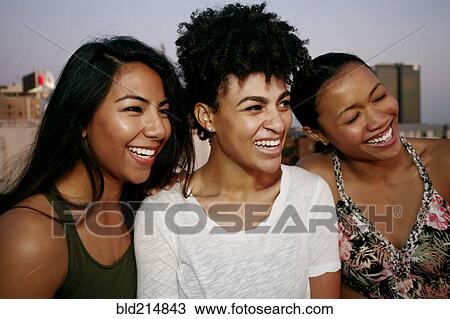 Women smiling on urban rooftop View Large Photo Image Stock Image - Women smiling on urban rooftop. Fotosearch