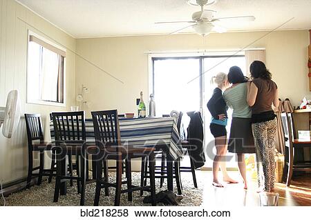 Women standing in dining room View Large Photo Image Stock Photo - Women standing in dining room. Fotosearch