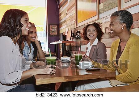 Stock Image - Women talking in cafe. Fotosearch