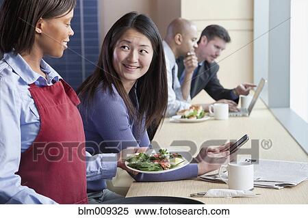 Worker serving woman salad in cafe View Large Photo Image Stock Photography - Worker serving woman salad in cafe. Fotosearch