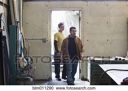 Stock Image - Workers entering factory door. Fotosearch