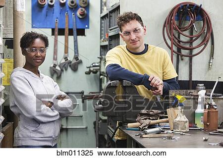 Stock Photography - Workers standing in workshop. Fotosearch