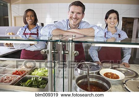 Workers standing together in cafe View Large Photo Image Stock Photo - Workers standing together in cafe. Fotosearch