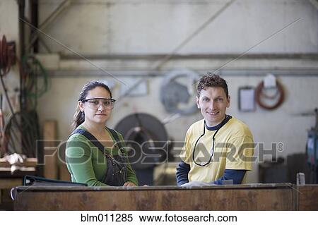 Stock Photography - Workers standing together in factory. Fotosearch