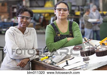Workers standing together in warehouse View Large Photo Image Stock Image - Workers standing together in warehouse. Fotosearch