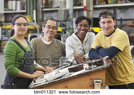Workers standing together in warehouse View Large Photo Image Stock Image - Workers standing together in warehouse. Fotosearch