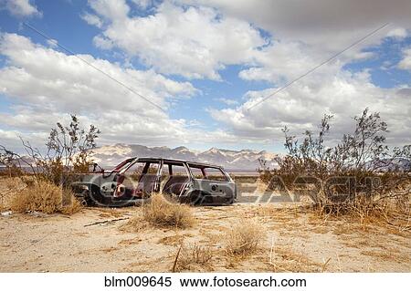 Wrecked car in barren area View Large Photo Image Stock Photography - Wrecked car in barren area. Fotosearch