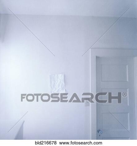Wrinkled paper on empty white wall View Large Photo Image Stock Photo - Wrinkled paper on empty white wall. Fotosearch