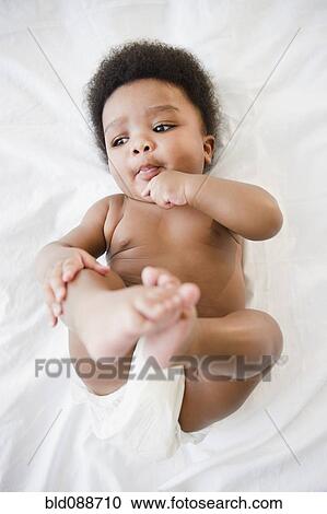 African American baby boy laying on bed View Large Photo Image Stock Image - African American baby boy laying on bed. Fotosearch