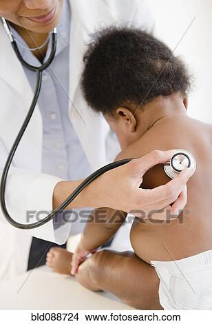 African American doctor listening to baby's breathing View Large Photo Image Picture - African American doctor listening to baby's breathing. Fotosearch