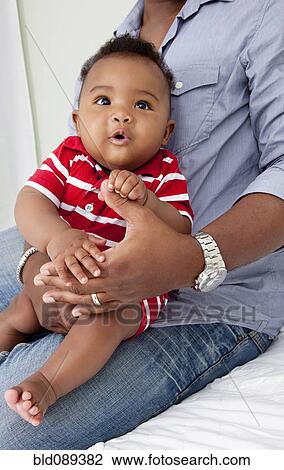 African American father holding baby son on lap View Large Photo Image Stock Image - African American father holding baby son on lap. Fotosearch