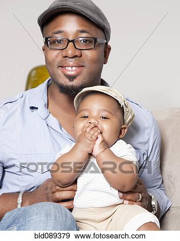 African American holding baby son in lap View Large Photo Image Stock Photo - African American holding baby son in lap. Fotosearch