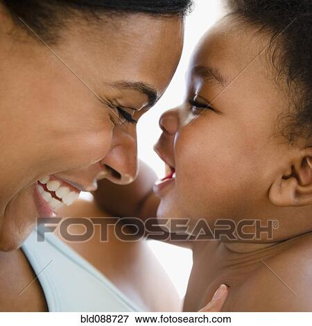 Stock Photo - African American mother bonding with baby boy. Fotosearch