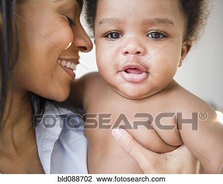 Stock Image - African American mother holding baby boy. Fotosearch
