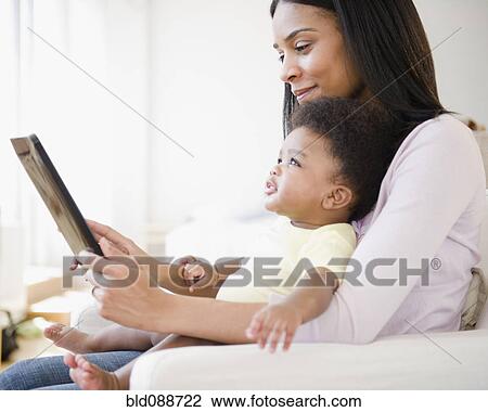 African American mother showing digital tablet to baby boy View Large Photo Image Stock Image - African American mother showing digital tablet to baby boy. Fotosearch