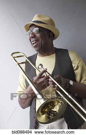 African American musician holding trombone View Large Photo Image Picture - African American musician holding trombone. Fotosearch
